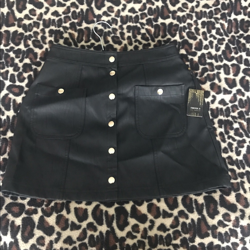 Black leather mini skirt with gold buttons